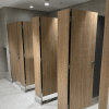 Durable compact laminate surface in floor-mounted partitions