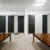 Overhead braced partitions provide structural stability in commercial restrooms.