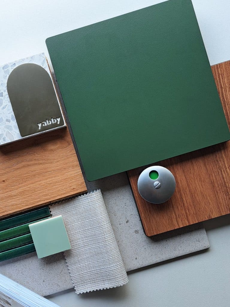 Biophilic Naturals palette — Sky, Sage Green, Native Walnut compact laminate samples with styling props