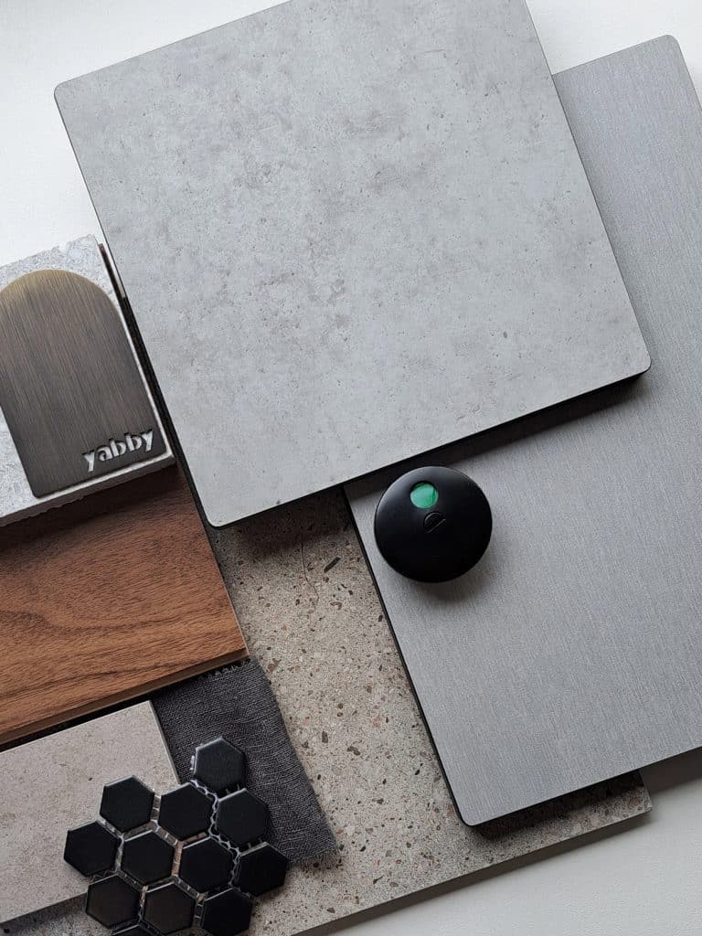 Industrial Elegance palette — Concrete, Brushed Grey, Alpine Ash compact laminate samples with styling props