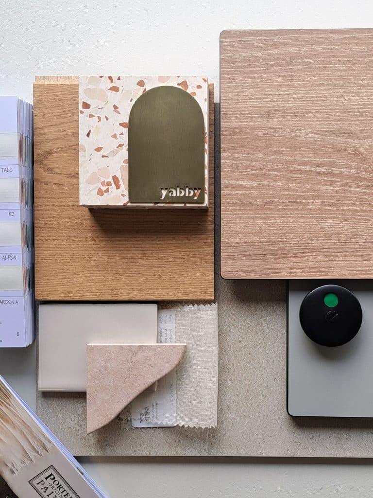 Moder-Terranean palette — Arctic White, Classic Grey, Washed Acacia compact laminate samples with styling props