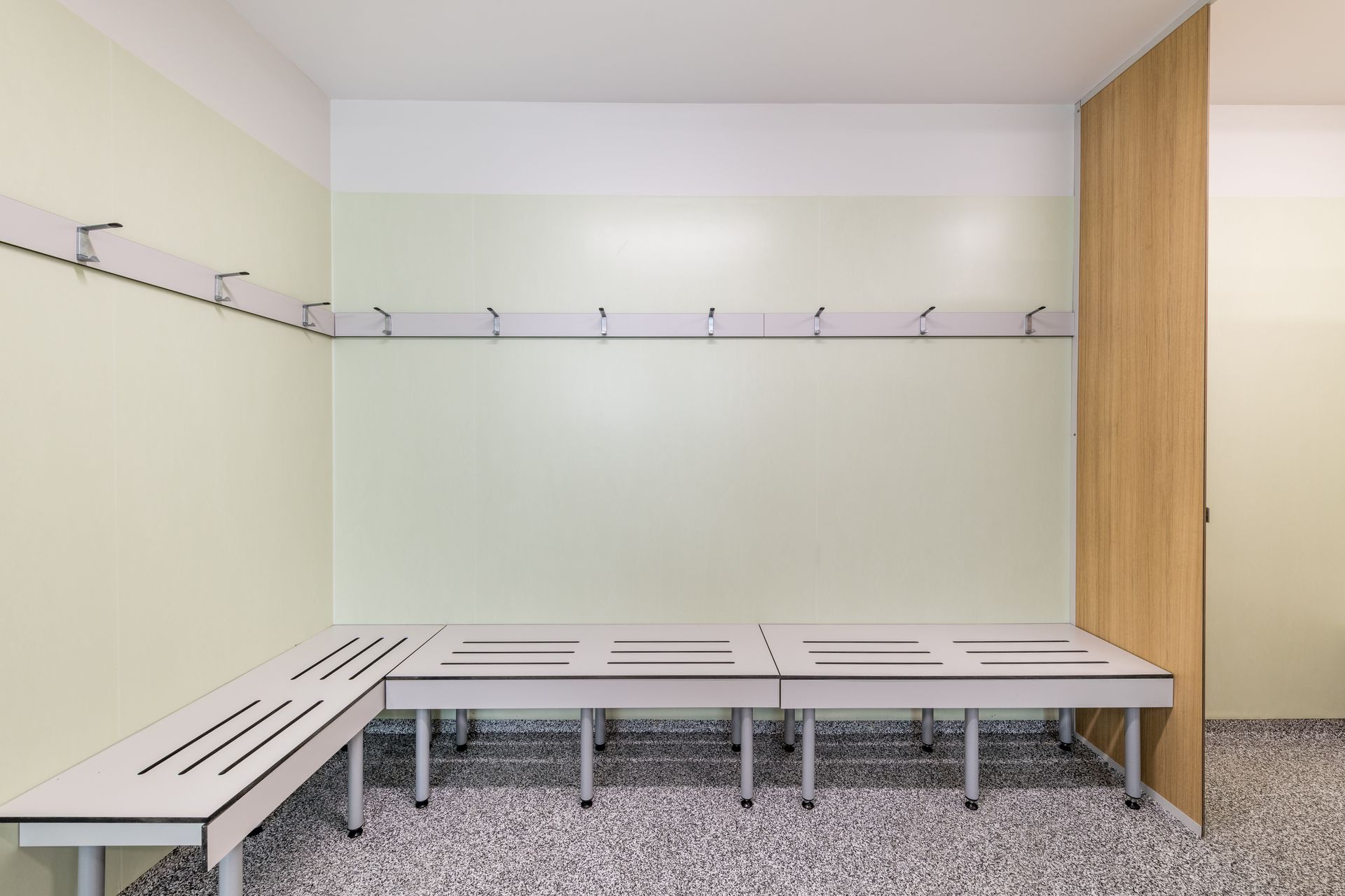 Wall mounted bench seating with integrated coat rail and anti-snag hooks