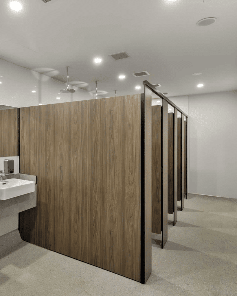 FOB floor mounted overhead braced toilet and shower partitions in a sports facility