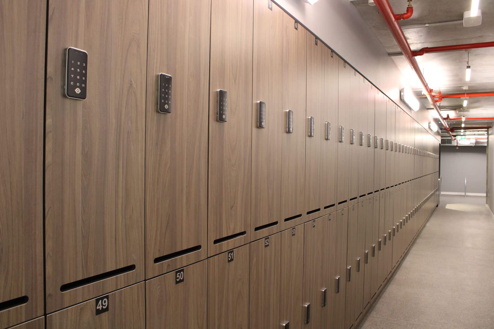 Plinth mounted compact laminate lockers in an industrial change facility